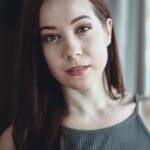 woman in gray cami top smiling