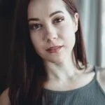 woman in gray cami top smiling