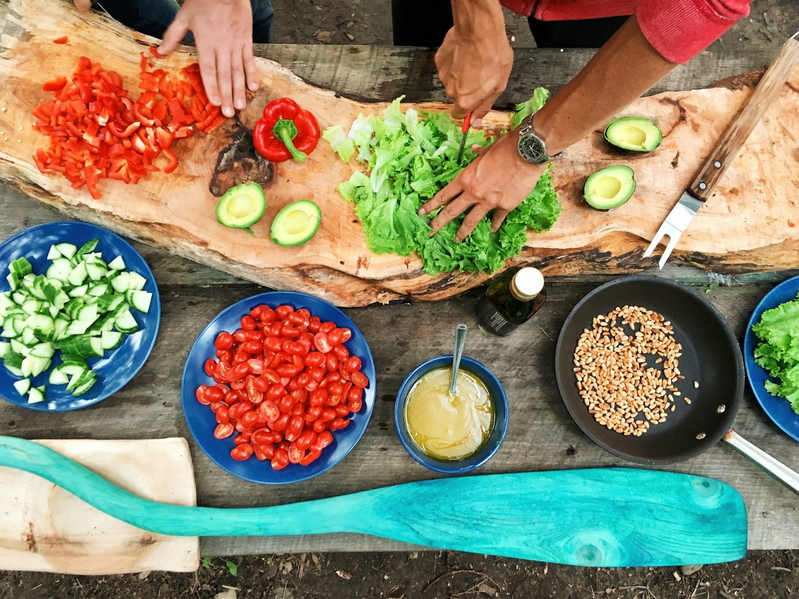 person slicing green vegetable in front of round ceramic plates with assorted sliced vegetables during daytime,activities to do in Marrakech