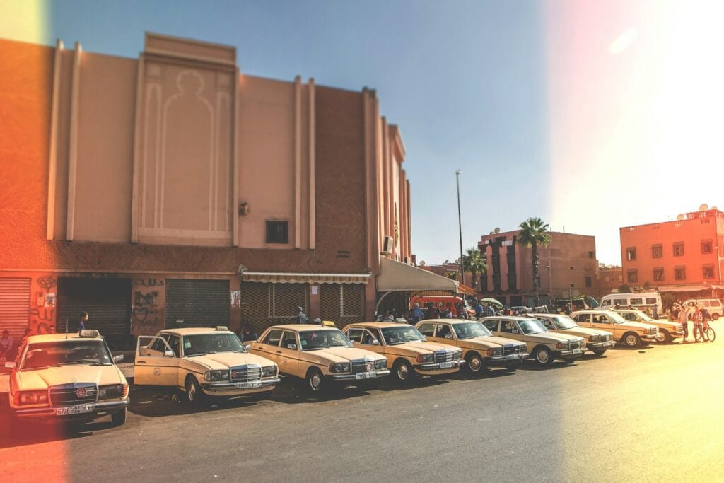 parked vehicles outside brown building during daytime,How to Take a Taxi in Marrakech
