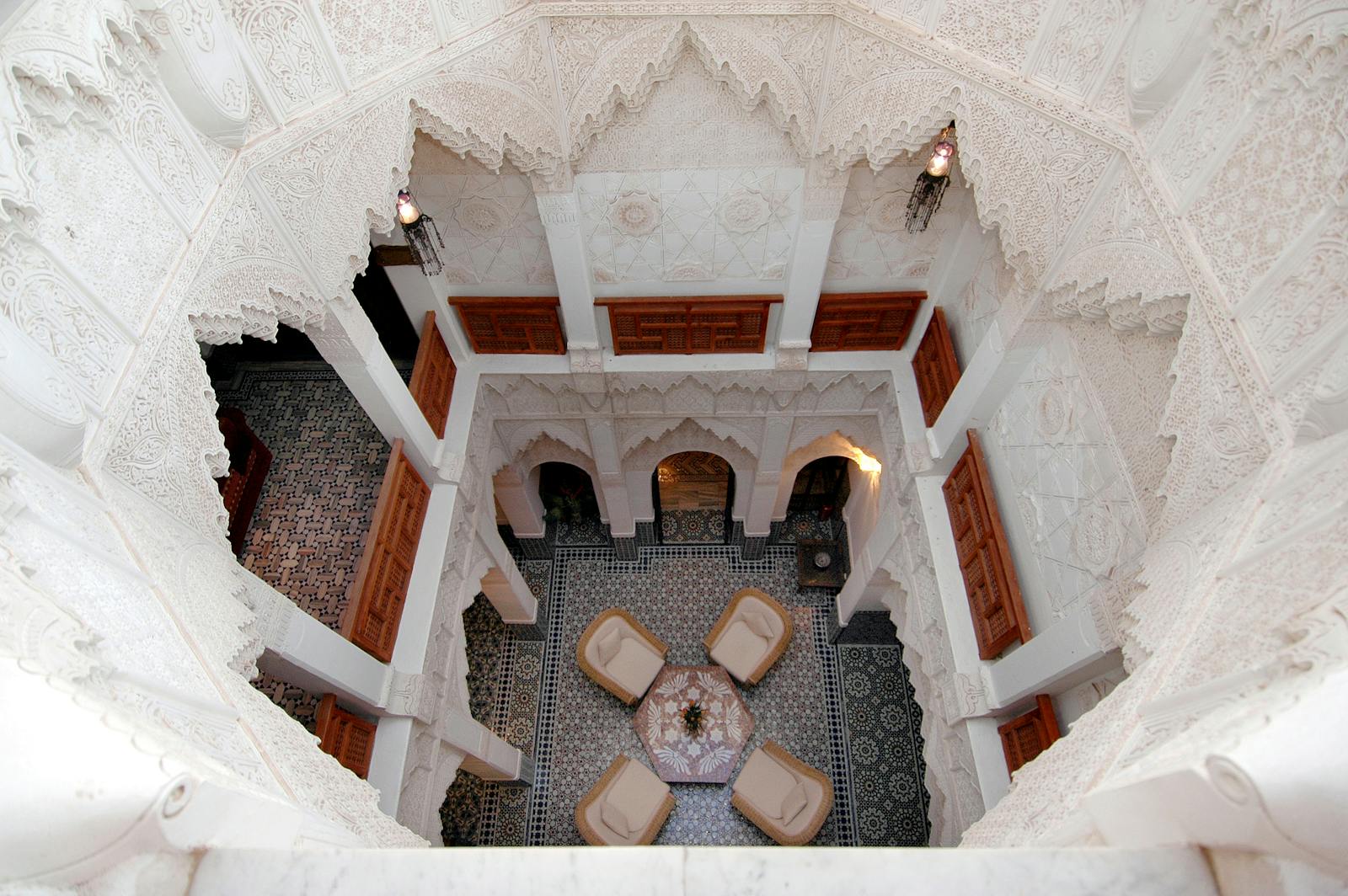 Stunning high-angle view of a traditional Moroccan riad courtyard in Marrakech, showcasing intricate architecture.Photo Spots in Marrakech