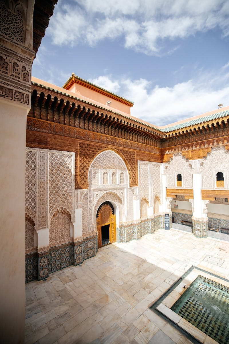Explore the intricate Islamic architecture of Ben Youssef Madrasa in Marrakesh, Morocco.