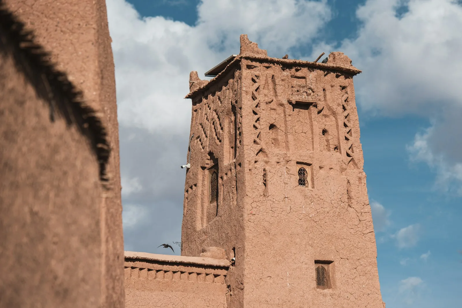 a tall brown building with a sky background,Ait Ben Haddou Movies Filmed