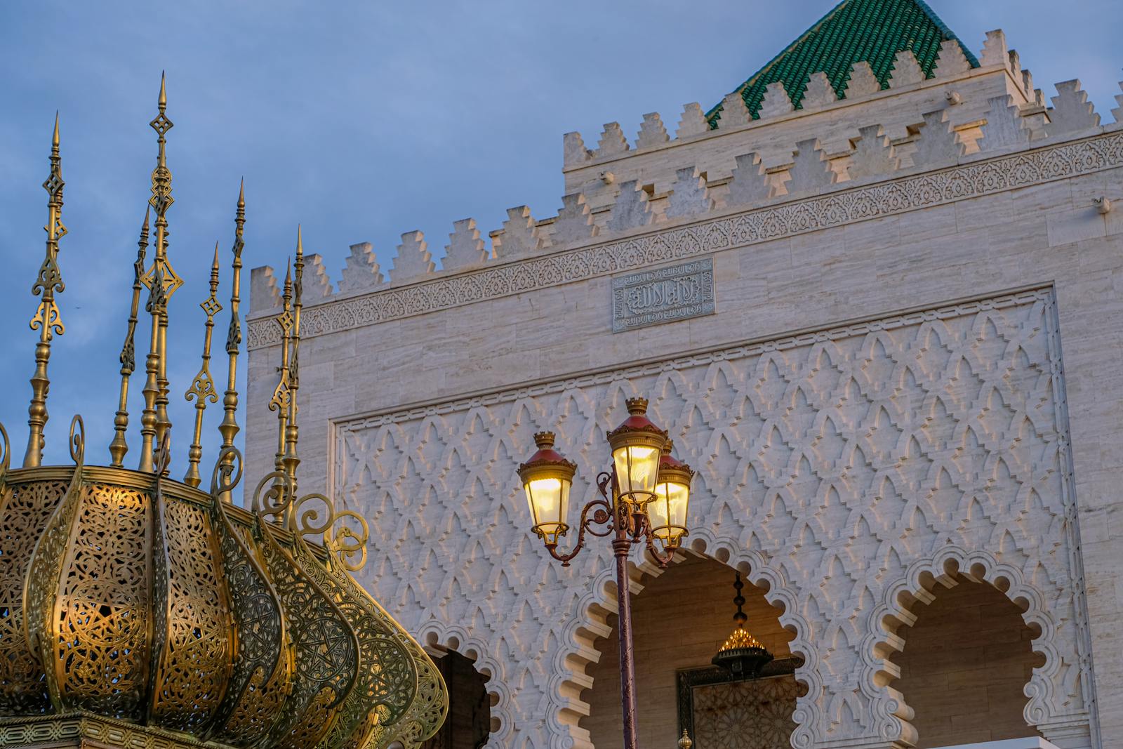 Beautiful Moroccan architecture with ornate lamps and intricate designs at sunset.Moroccan Heritage