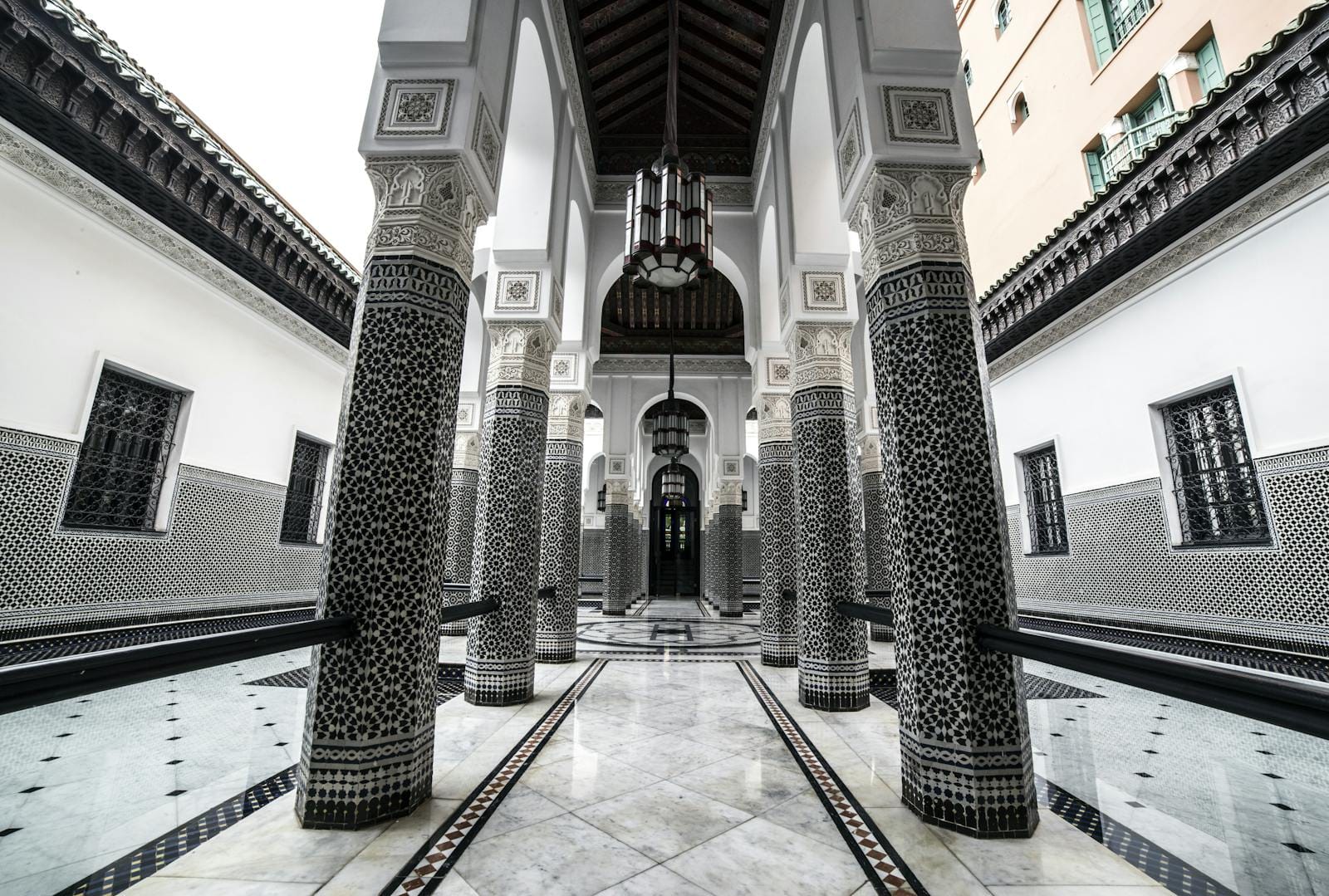 Elegant Moroccan architecture with intricate columns and arches in Marrakech.Photo Spots in Marrakech