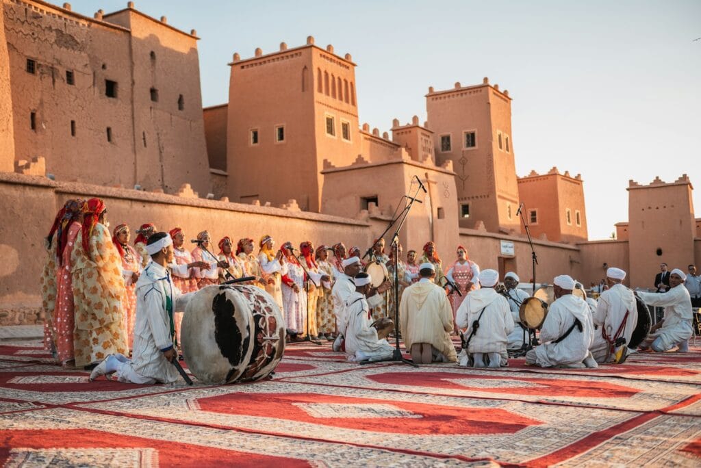 a group of people standing on top of a rug,Traditional Music Instrument