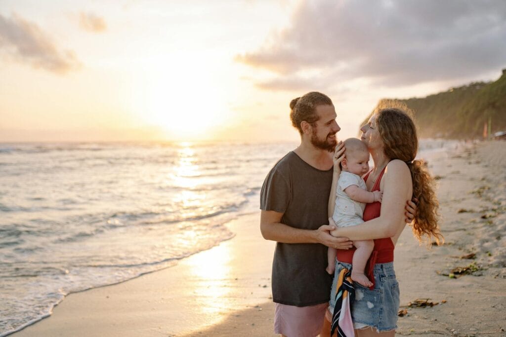 A joyful family holding each other while watching the sunset on a tropical beach.Morocco Family Friendly Tour,morocco family friendly tours