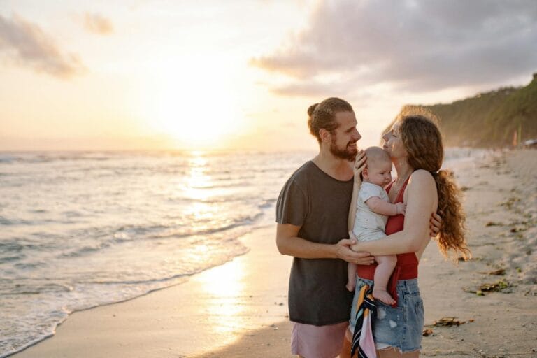 A joyful family holding each other while watching the sunset on a tropical beach.Morocco Family Friendly Tour,morocco family friendly tours
