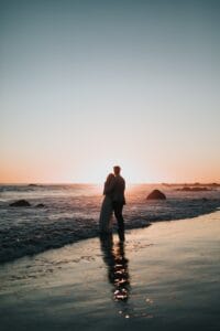silhouette photo of couple standing on beach watching sunset,Honeymoon in Morocco