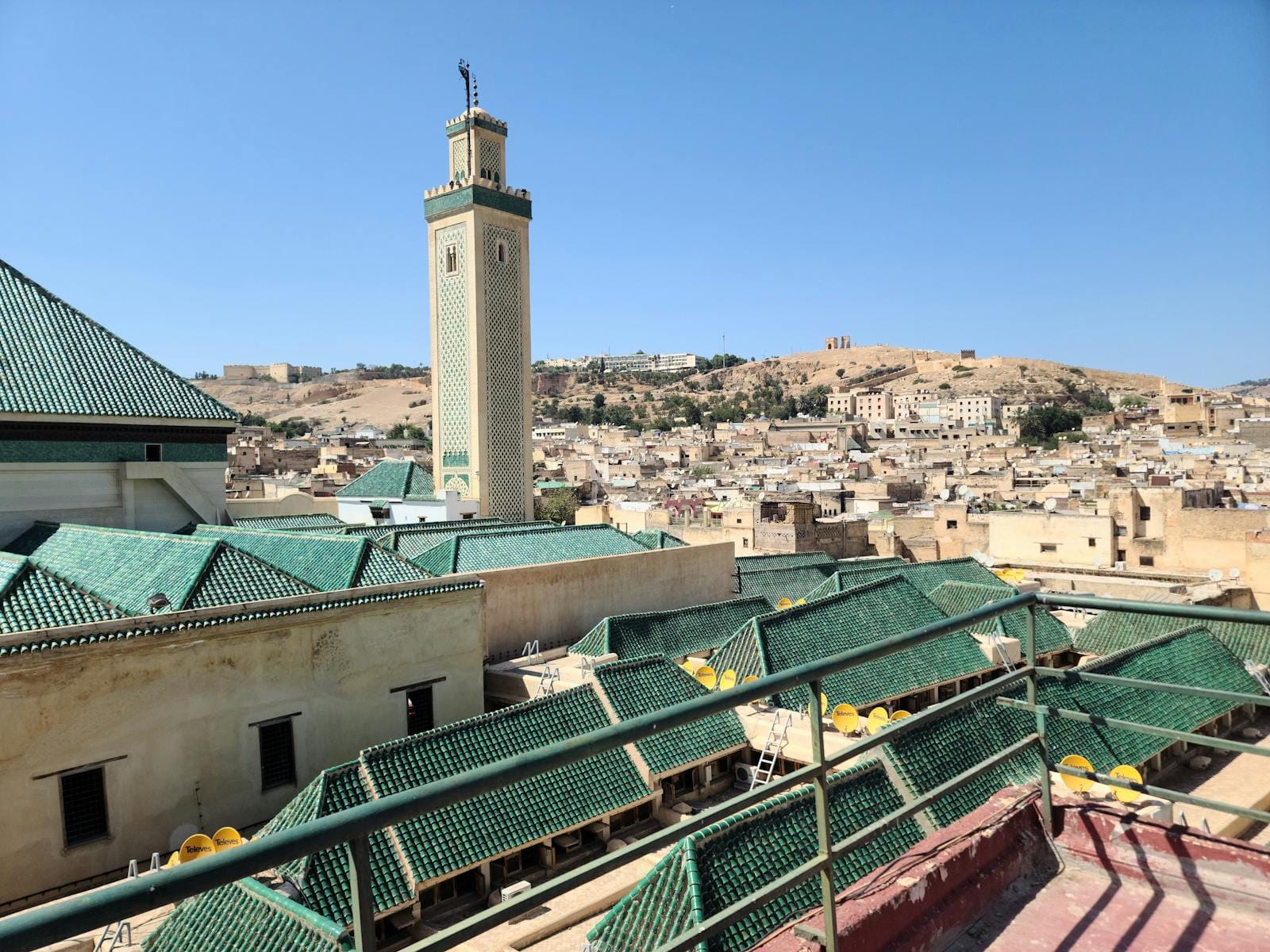 Aerial view of Fes with Kairaouine Mosque minaret under a clear blue sky.Fez December Weather