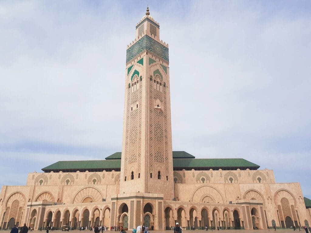 brown concrete building under blue sky during daytime.Hassan II Mosque