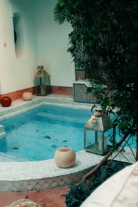 Serene courtyard pool with Moroccan lanterns in a traditional Marrakesh riad.moroccan riad