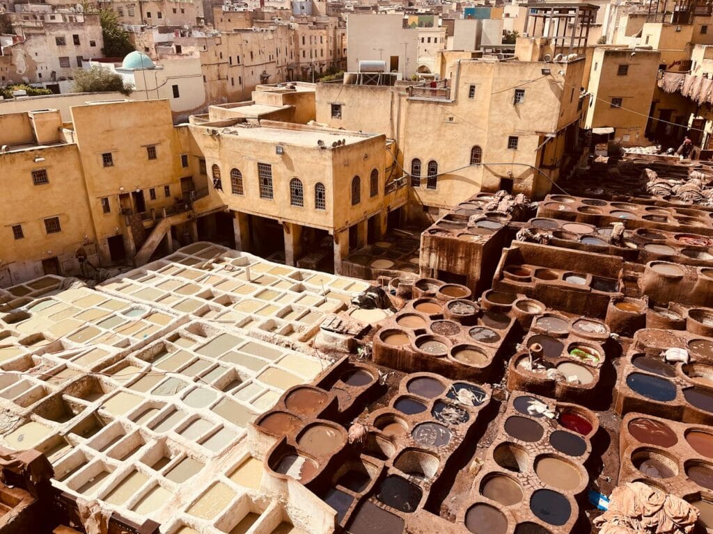 Aerial photo of vibrant traditional tannery in Fez, Morocco, showcasing ancient leather dyeing process.Chouara Tannery