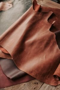 High-quality brown leather sheets displayed in a crafting workshop.Chouara Tannery