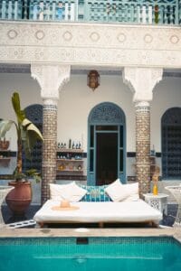 Elegant Moroccan courtyard featuring a luxurious pool and traditional decor.moroccan riad
