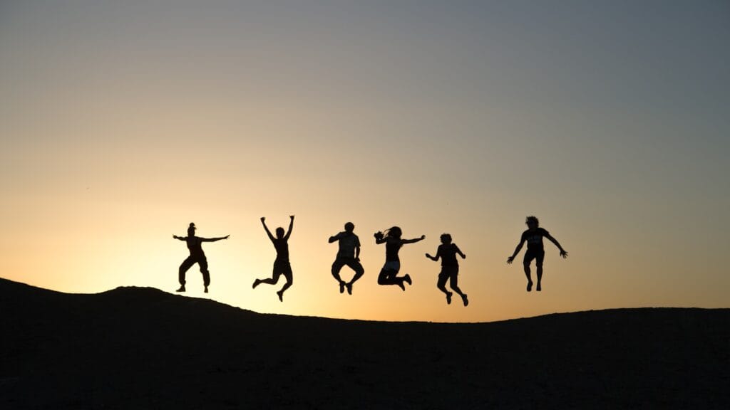 six silhouette of people jumping during sunrise,family Morocco tour packages