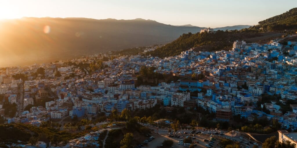 a view of a city with mountains in the background,best places to visit in morocco in february