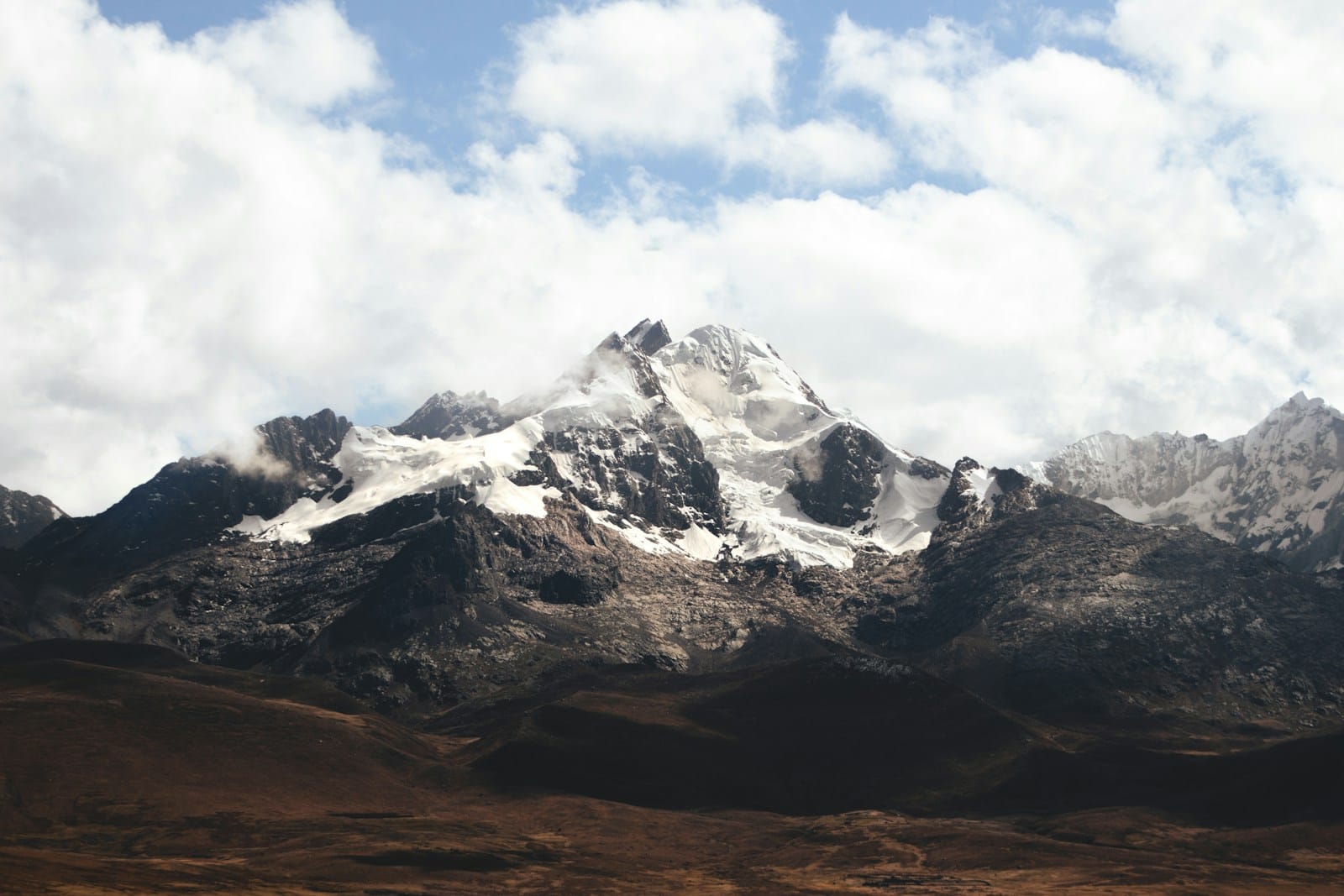 a mountain range with snow capped mountains in the background,atlas mountains weather december
