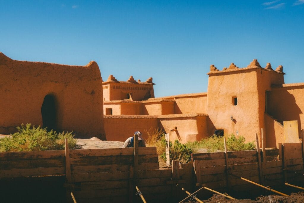 Traditional mud brick buildings under a clear blue sky.