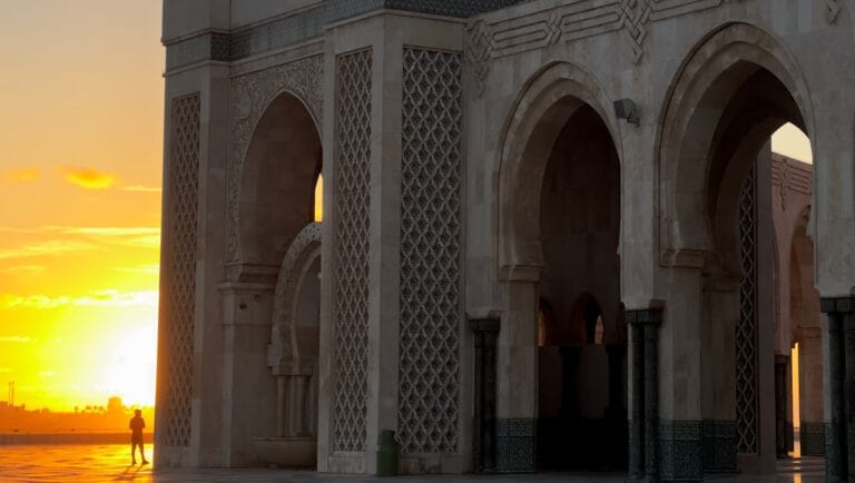 a person standing in front of a building at sunset.February for Ladies
