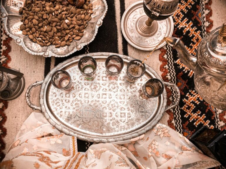 Elegant Moroccan tea setup on a decorative tray with almonds in Marrakesh, Morocco.tea in morocco