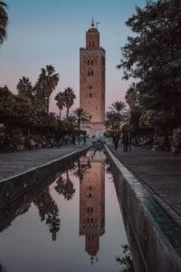 a tall tower with a clock on top of it.Morocco in July