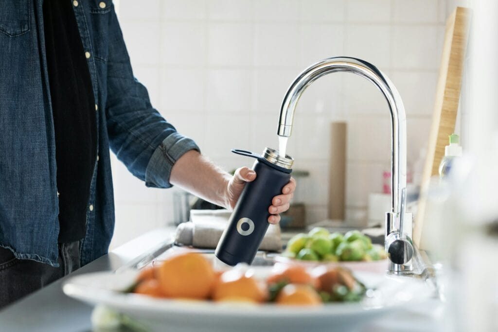 person holding stainless steel faucet,Tap Water in Morocco