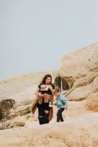 man and woman standing on brown rock formation during daytime,Morocco with Family