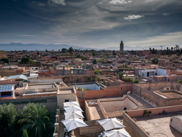 a view of a city with a clock tower in the distance.Marrakech in February