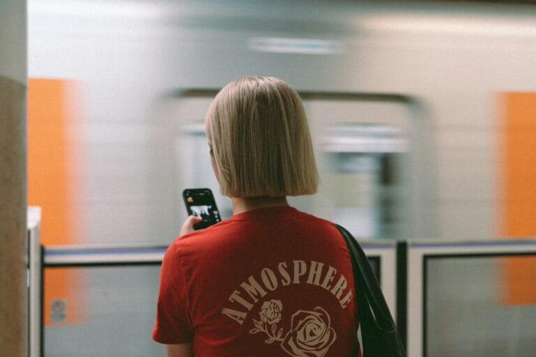 A woman in a red shirt is using her cell phone.phone in morocco