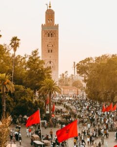a large group of people walking down a street.Marrakech or Casablanca