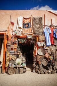 assorted clothes hanged on brown wooden cabinet.Tipping in Morocco