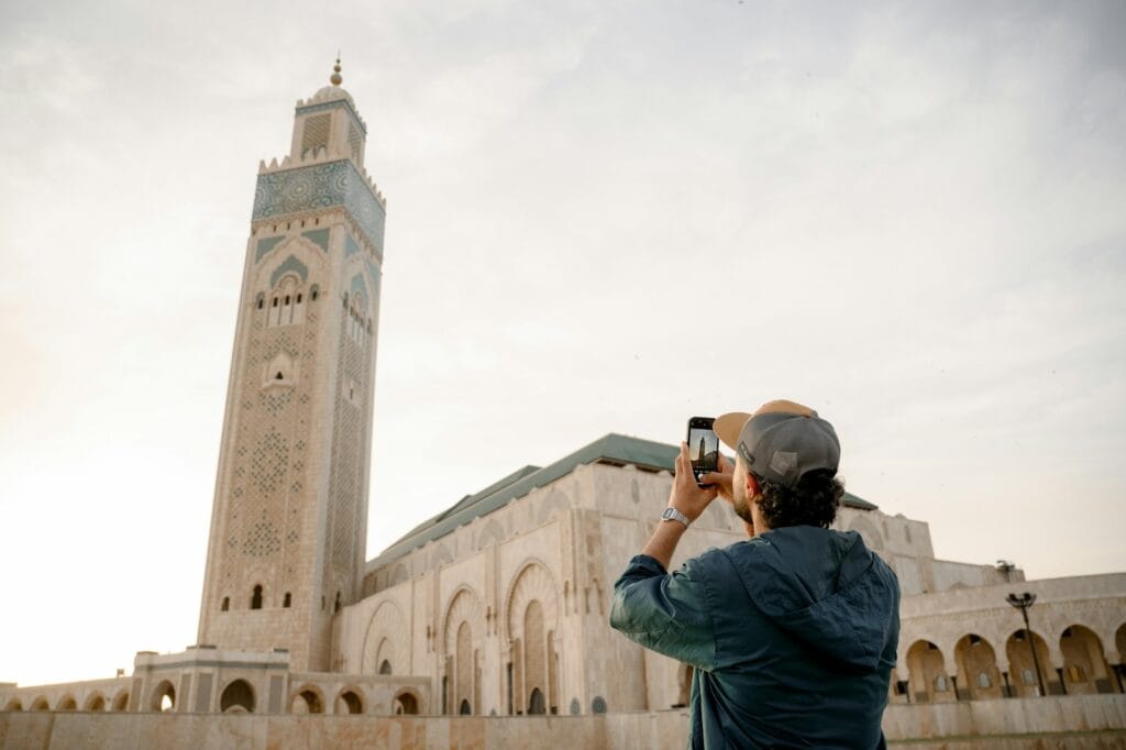 Man takes a photo of a majestic mosque.