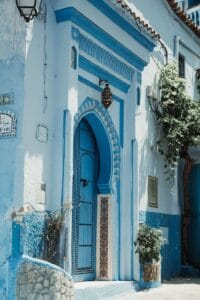 A blue and white building with a blue door.Morocco in August