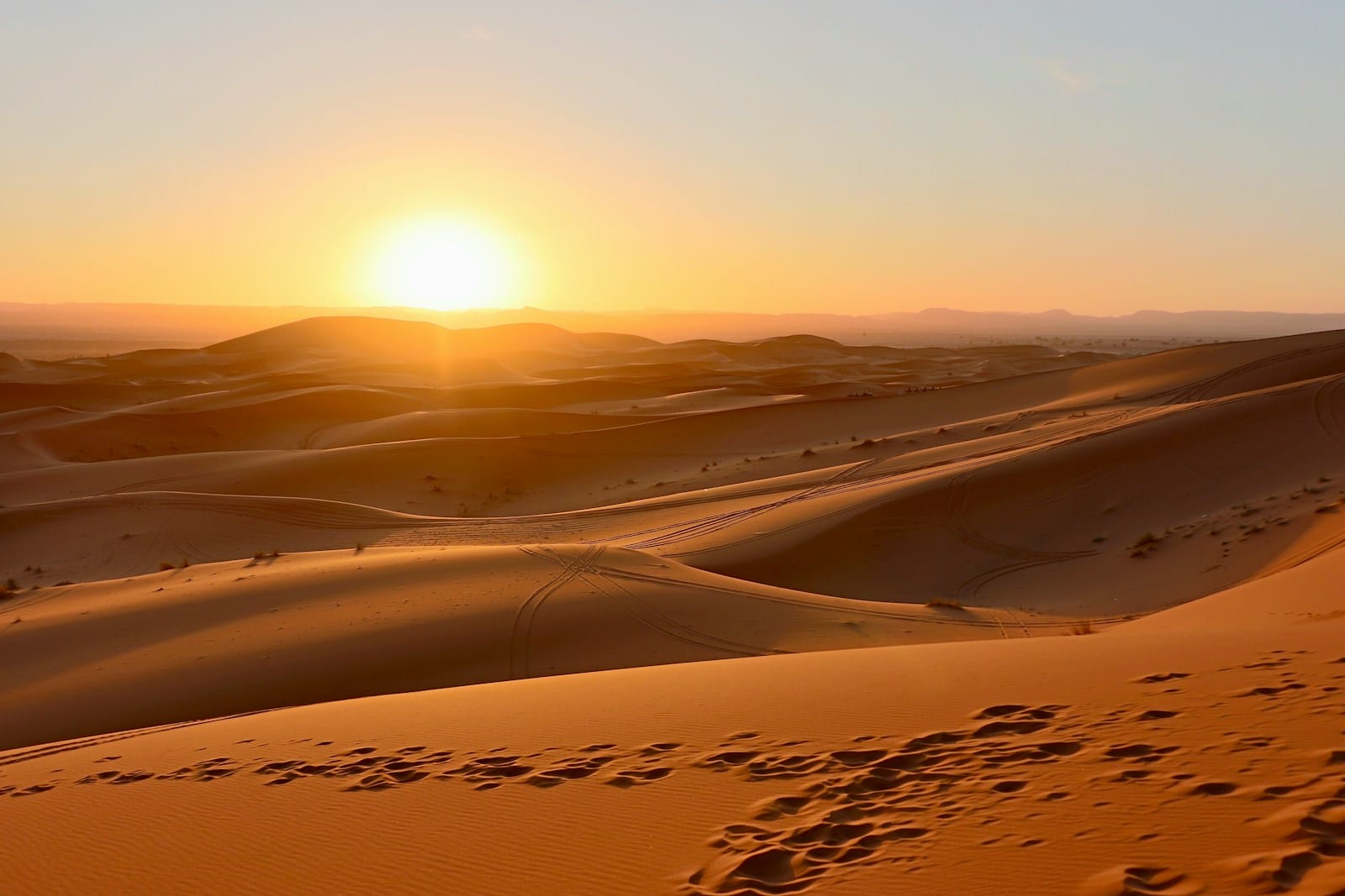brown sand field during sunset.Hottest City in Morocco
