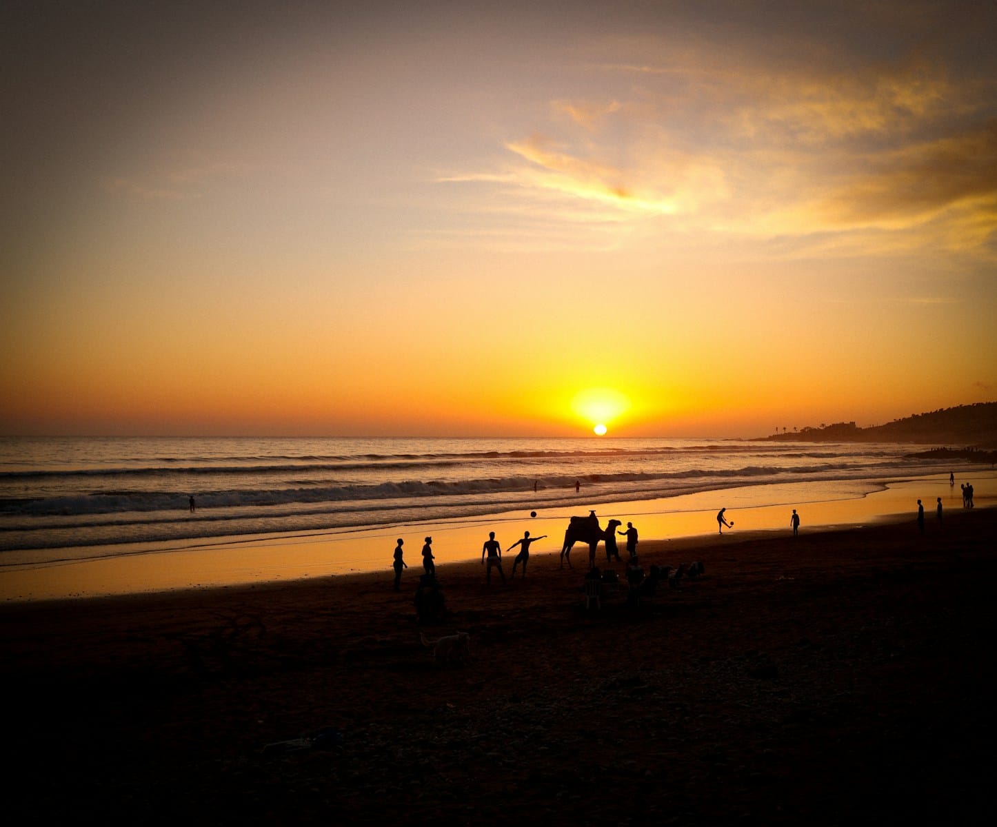 a group of people standing on top of a beach.Morocco with kids