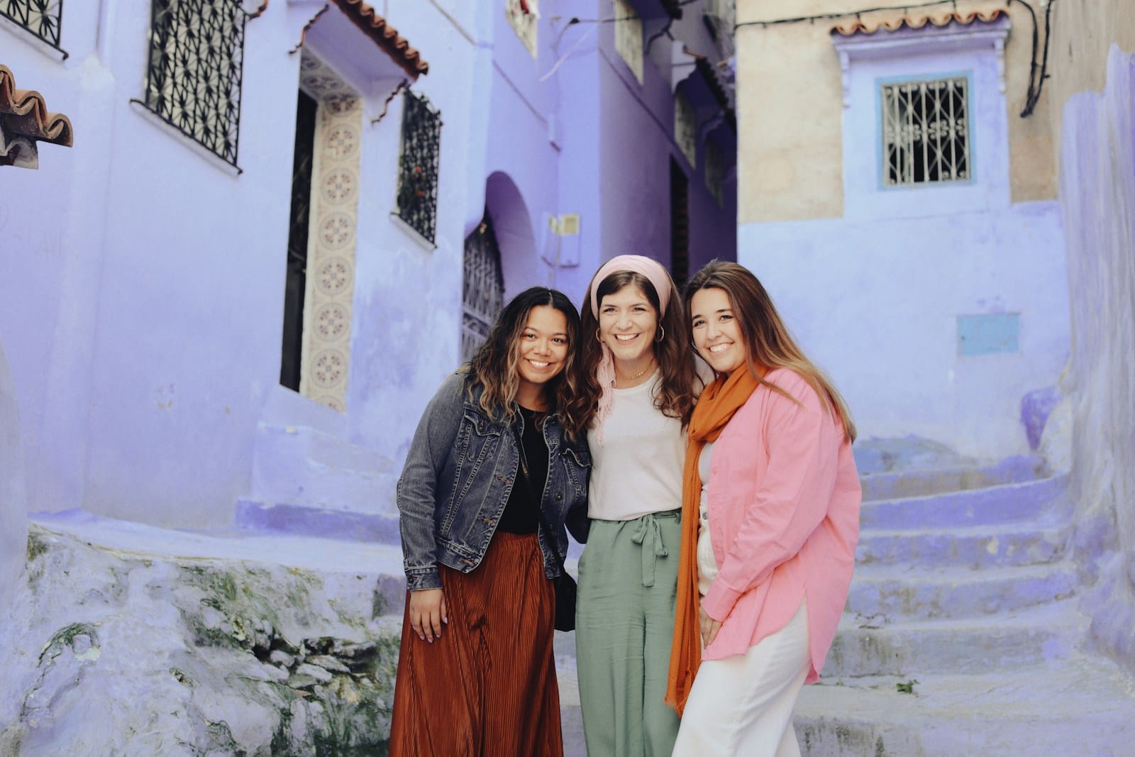 a group of women standing next to each other in front of a building.Headscarf in Morocco