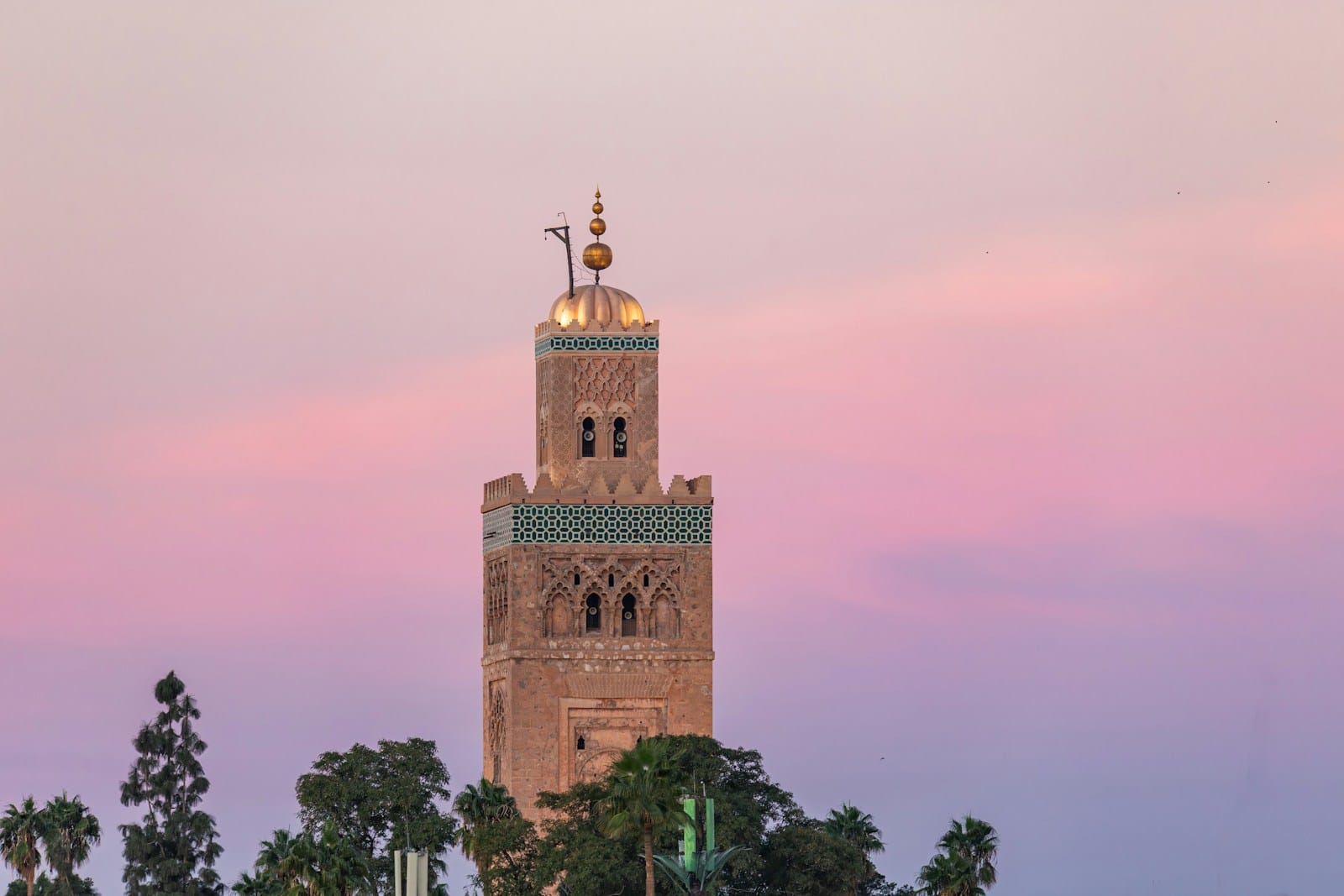 A tall tower with a clock on top of it.shorts in Morocco