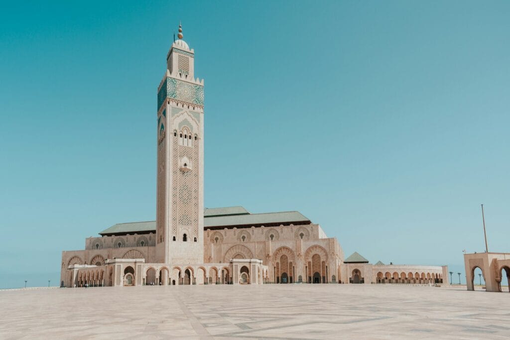 a large building with a tall tower with Hassan II Mosque in the background