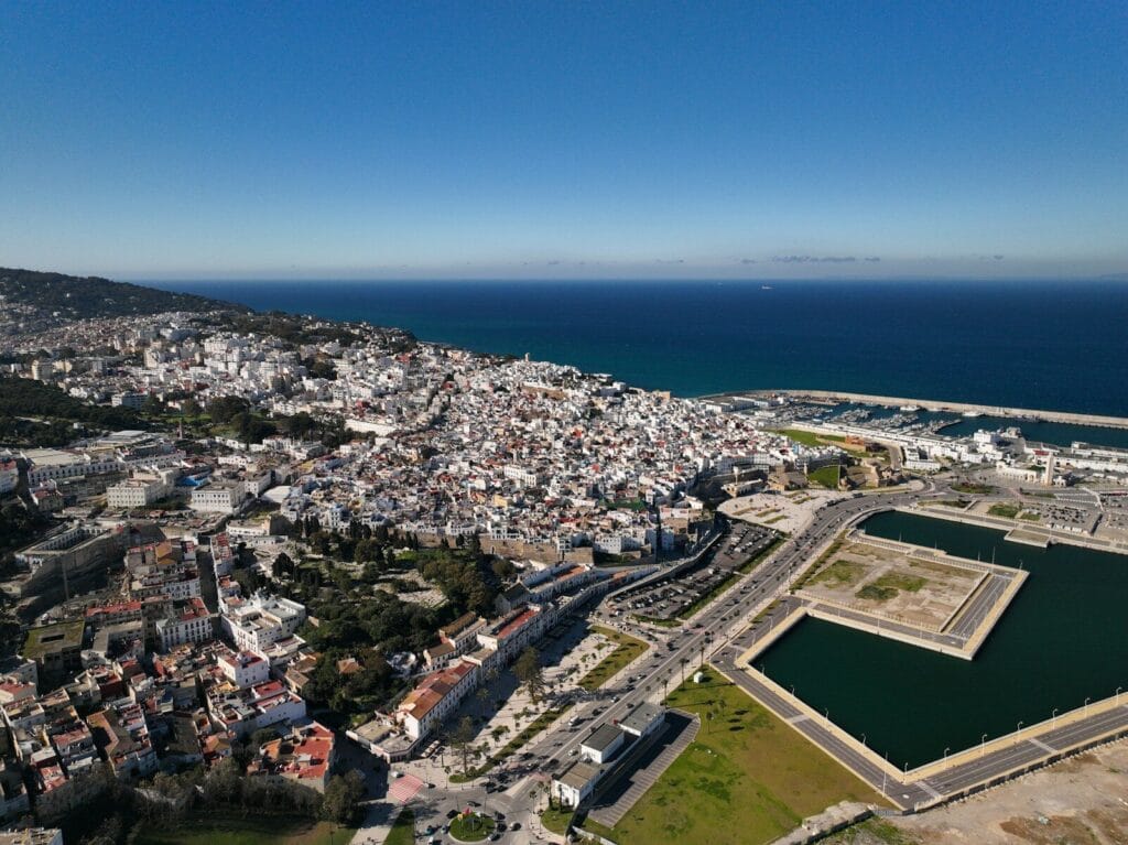an aerial view of a city and a body of water.Is Tangier Morocco Safe