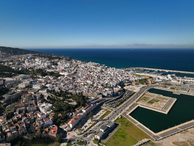 an aerial view of a city and a body of water.Is Tangier Morocco Safe