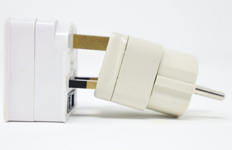 white adapter on white surface.plug