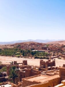 Breathtaking landscape of Aït Benhaddou, an iconic fortified village in Morocco, under a clear sky.Ouarzazate Skoura