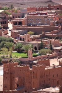 brown concrete building near green trees during daytime.Ouarzazate Skoura