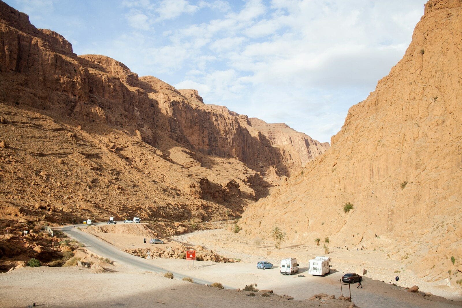 A road in the middle of a desert with mountains in the background