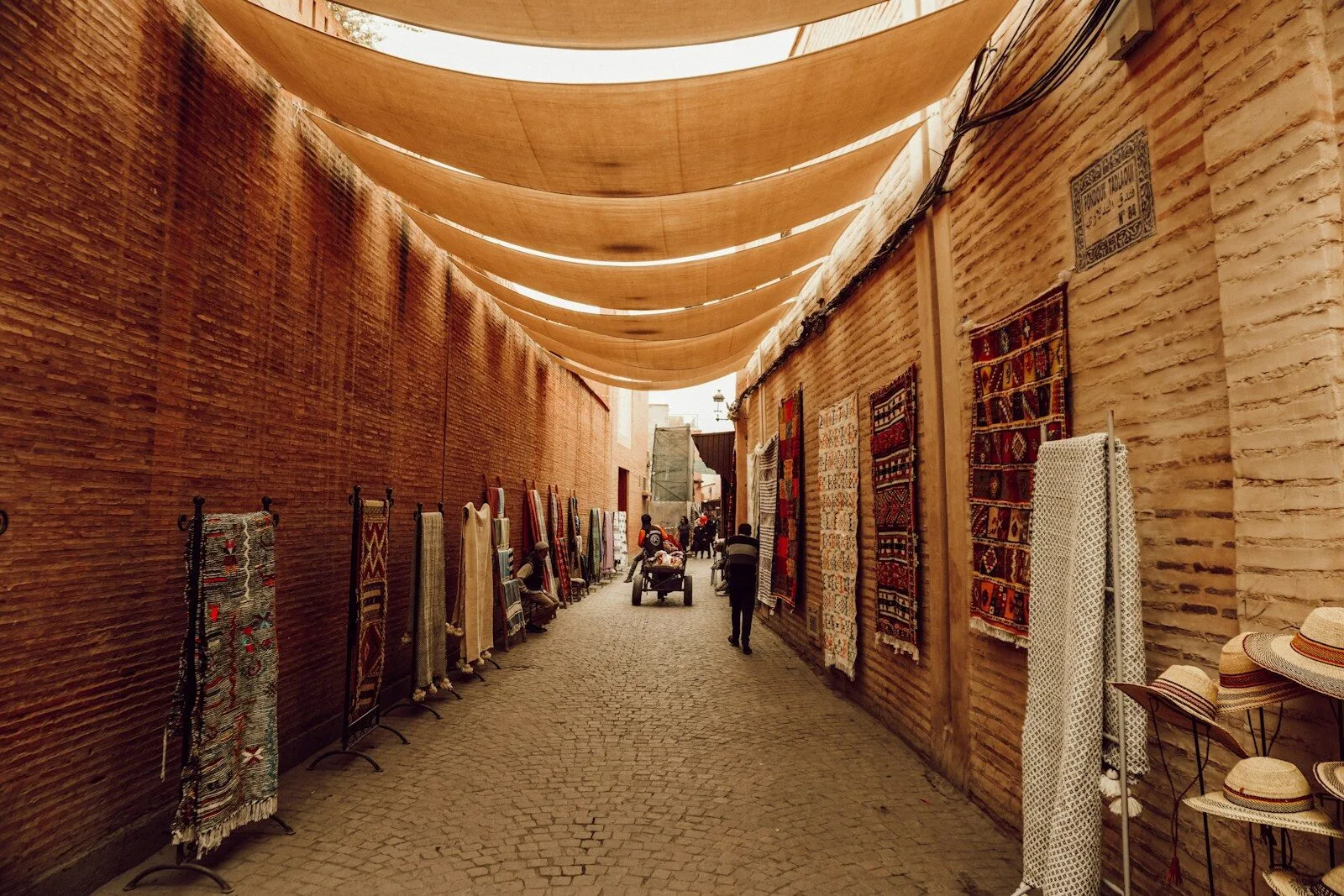 a narrow alley with a few people walking down it.Moroccan Arabic language characteristics