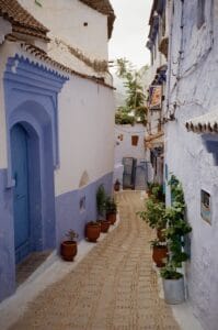 Explore the serene narrow streets of Chefchaouen, the Blue Pearl of Morocco, showcasing traditional architecture.
