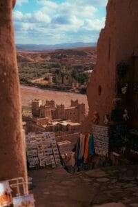 Scenic view of Aït Benhaddou, a traditional Berber village, with market stalls in the foreground.berber village Morocco