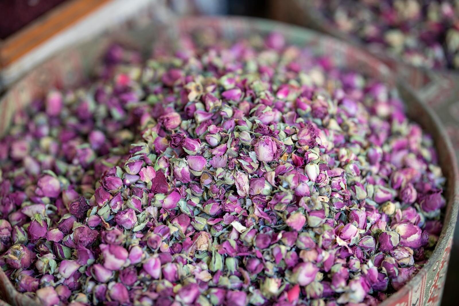 Aromatic pink rose buds piled in a bowl, perfect for tea, potpourri, or decor.Valley of Roses Morocco
