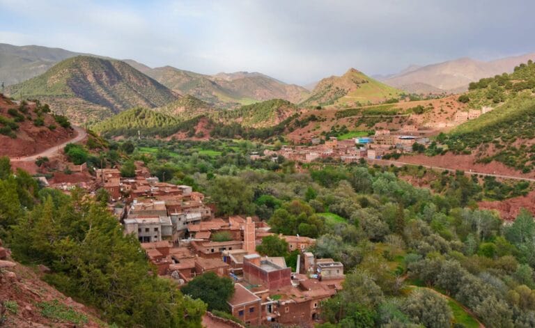 Scenic aerial view of Ait Barka village amidst lush green valleys and rugged mountains.berber village Morocco​